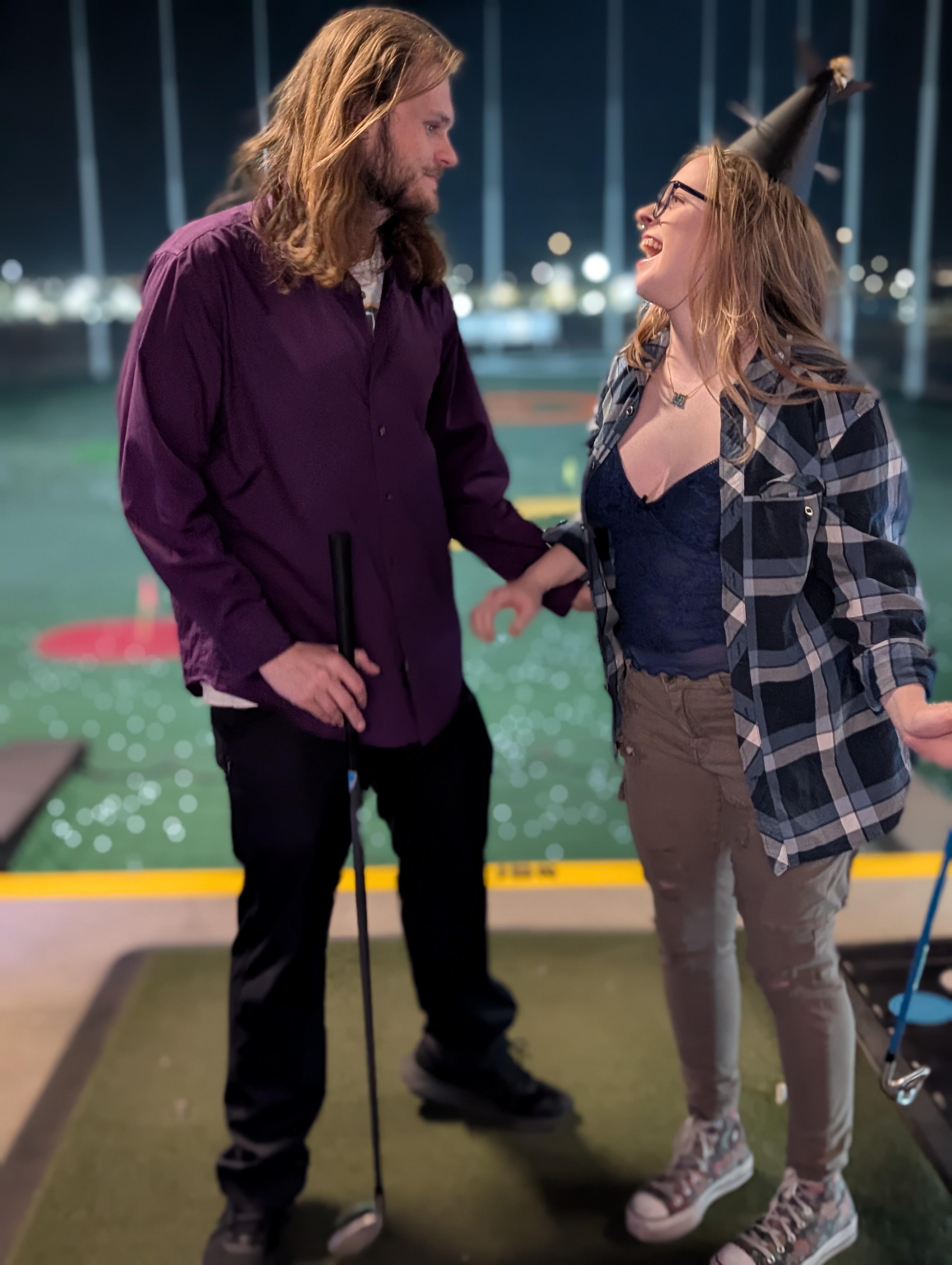 Stockton and his girlfriend laughing at Topgolf