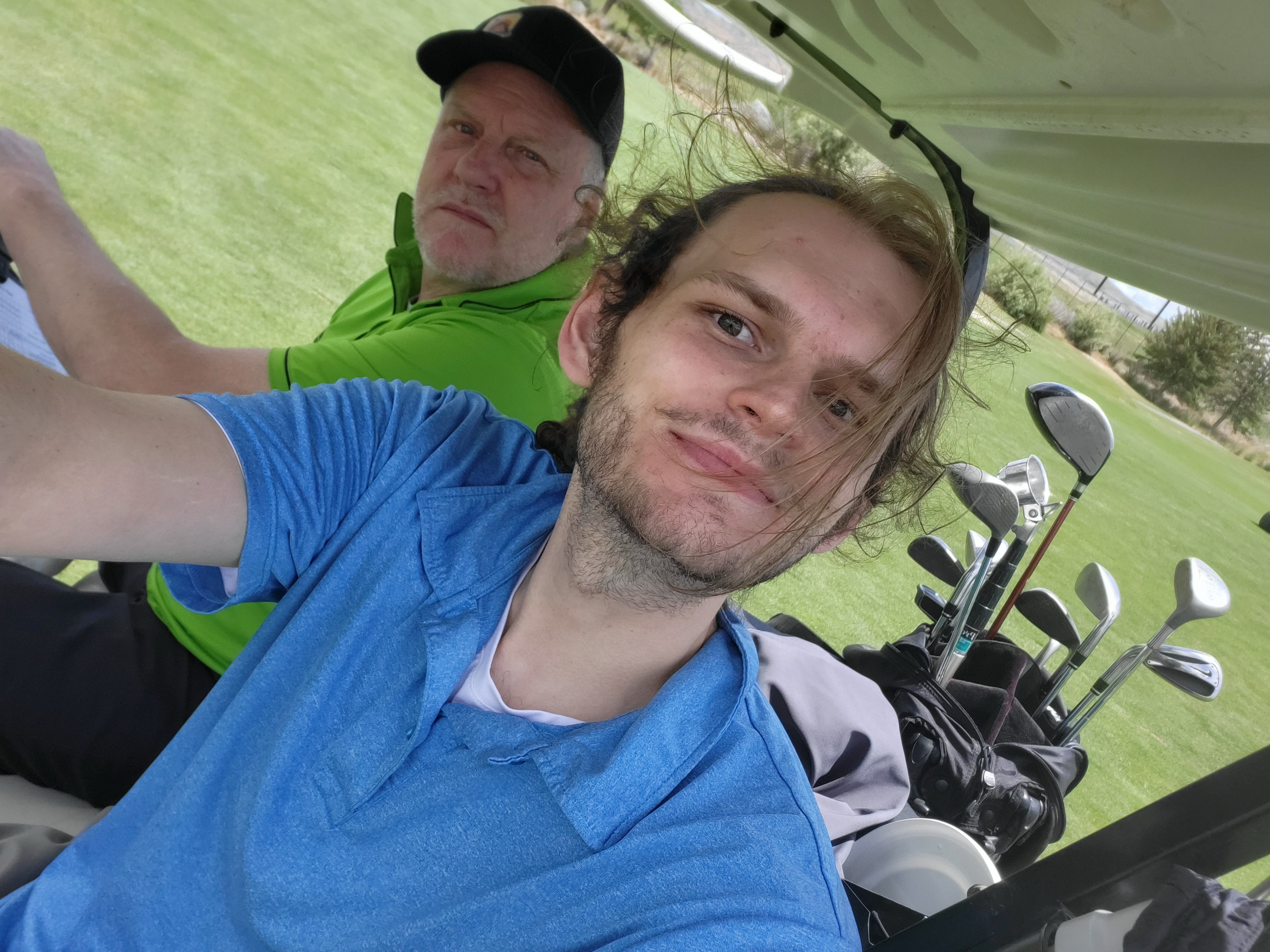 Stockton and his dad riding in a golf cart
