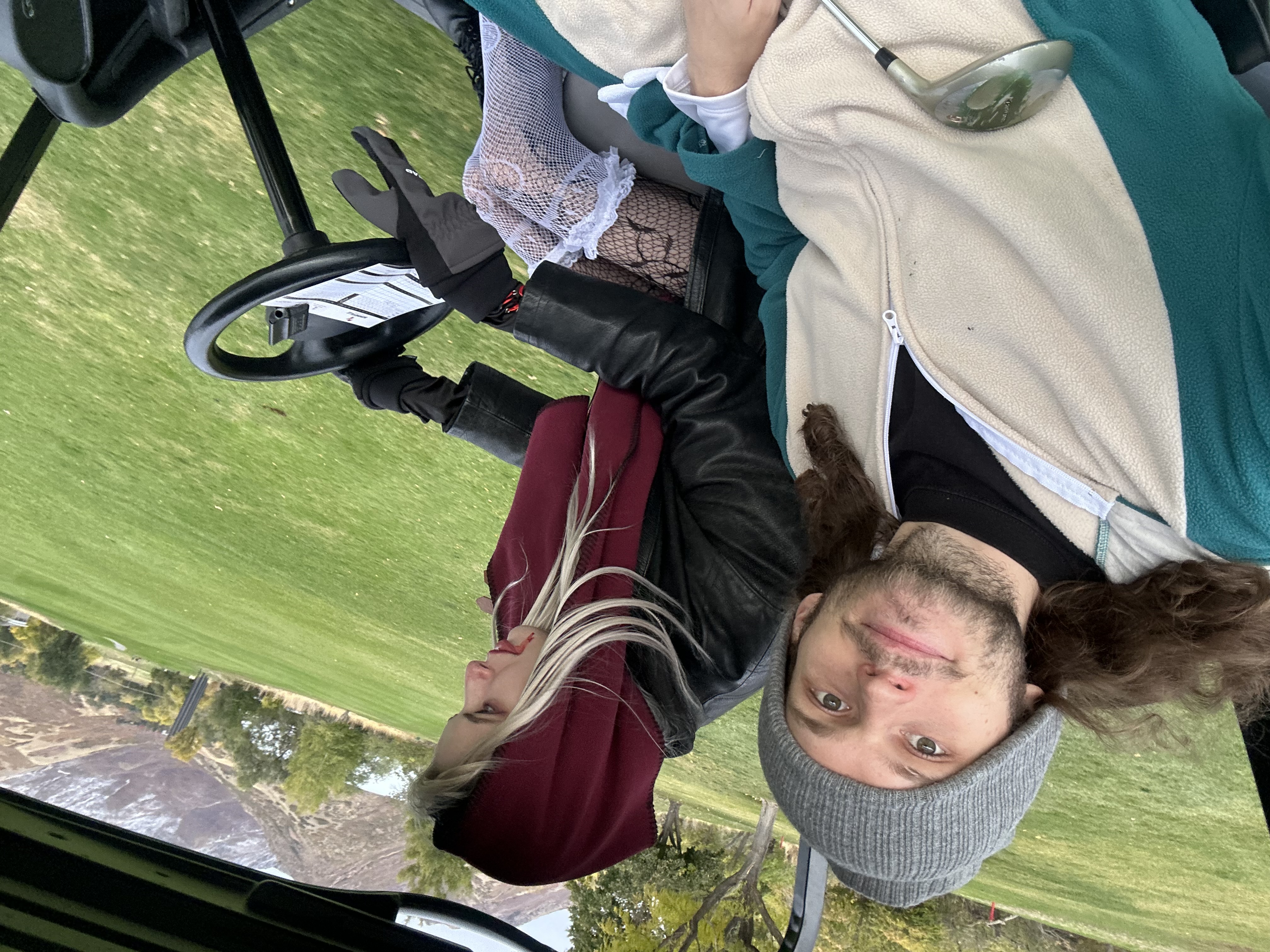 Stockton dressed as Snorlax and a friend dressed as a vampire golfing on Halloween
